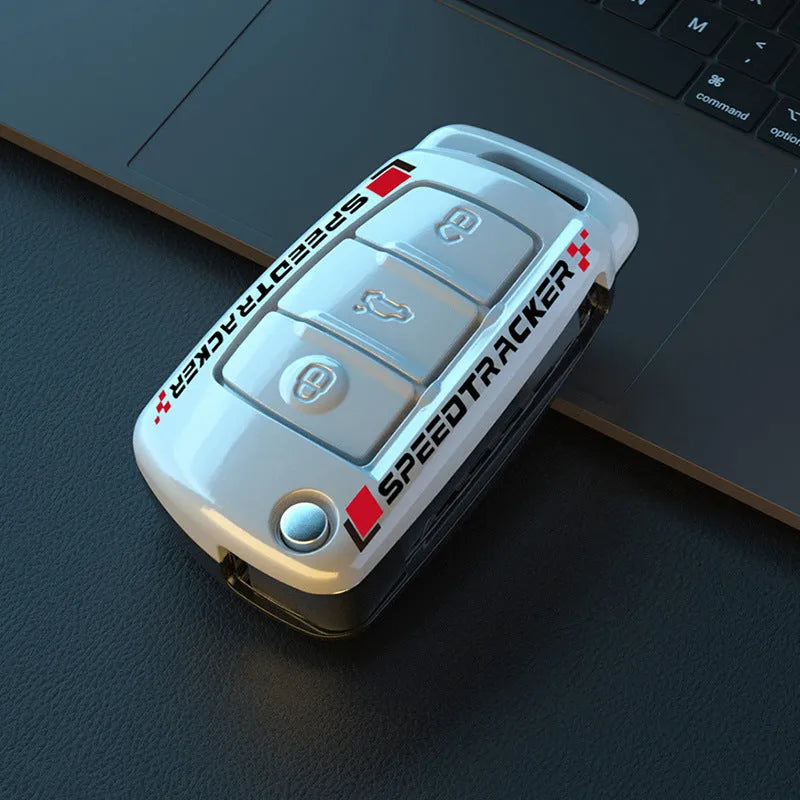 Carbon fibre style car key cover with a small mirror, shown in black and white colour options.