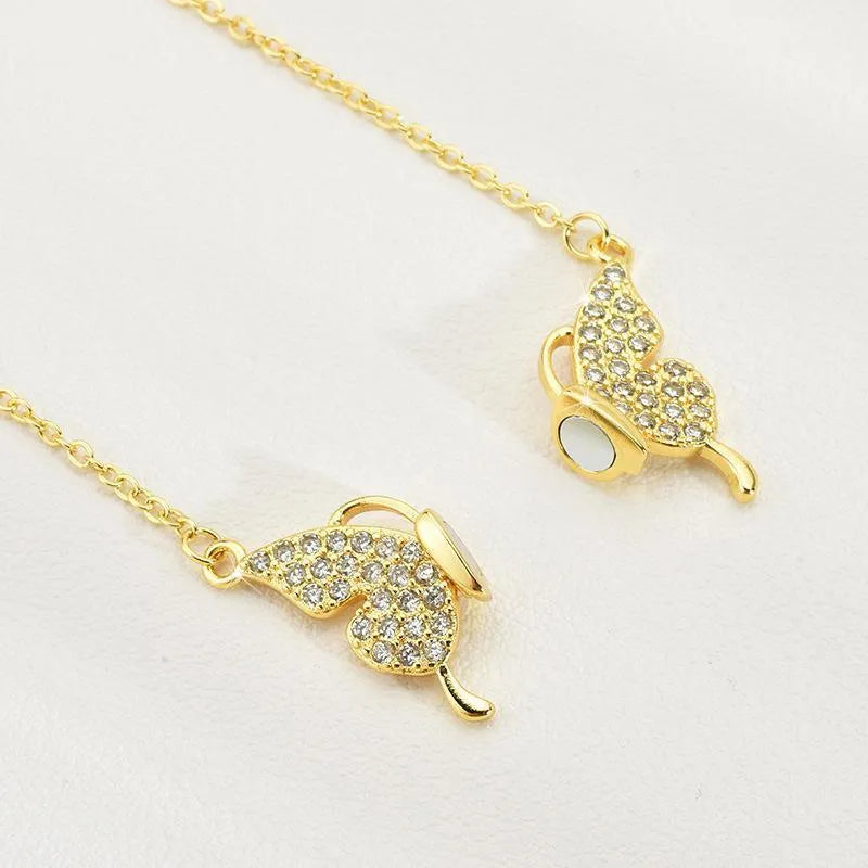 Women's clavicle necklace with magnetic butterfly pendant on twisted chain in gold finish