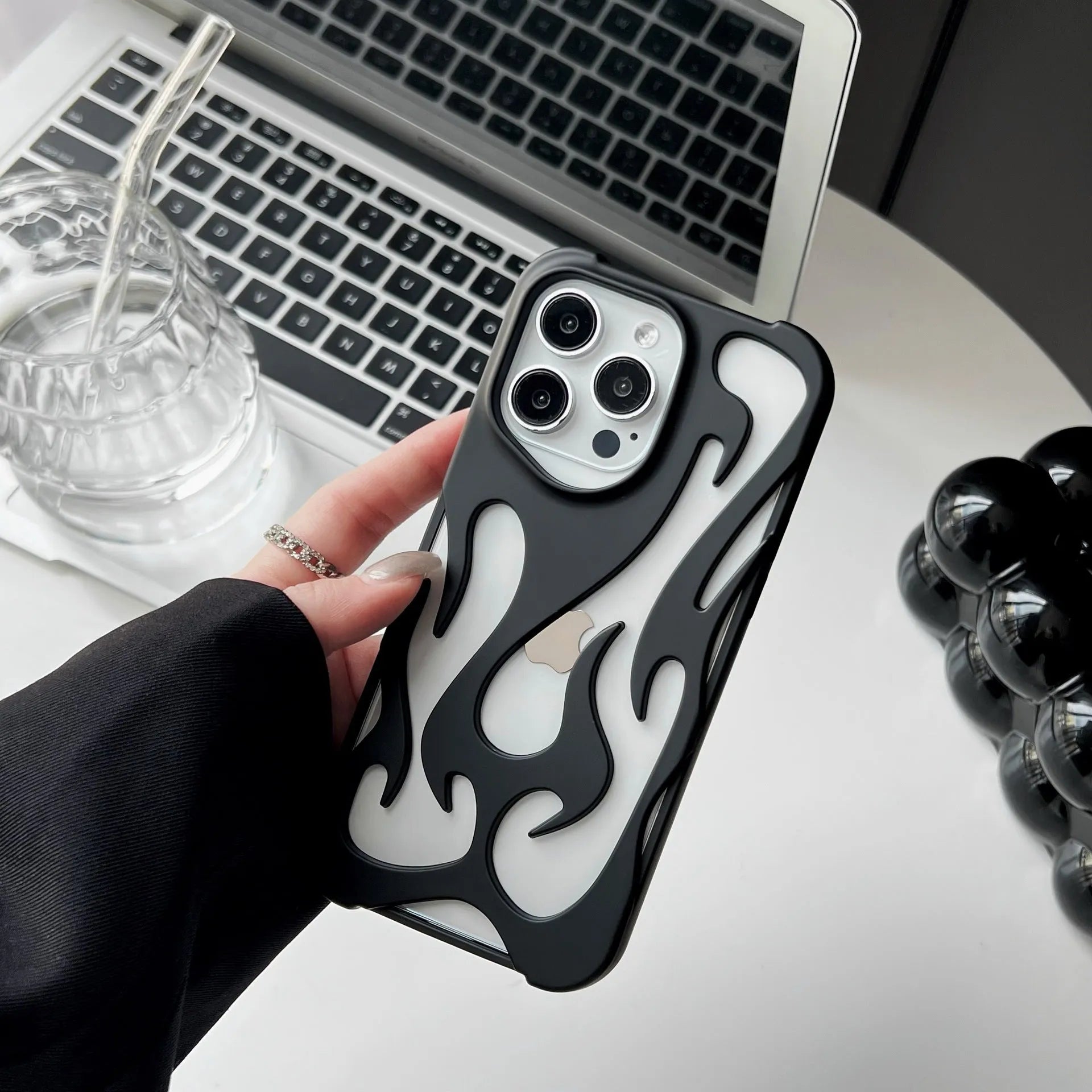 Electroplated hollow flame pattern design on a soft TPU iPhone case, shown in a silver finish.