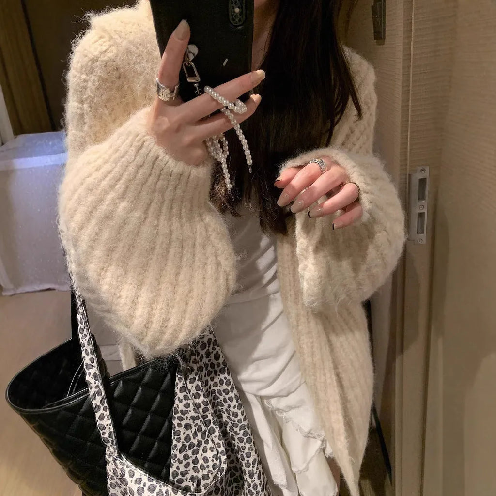 Women's loose-fit hooded cardigan in thick fabric, shown in dark grey, brown, and milky white colours.