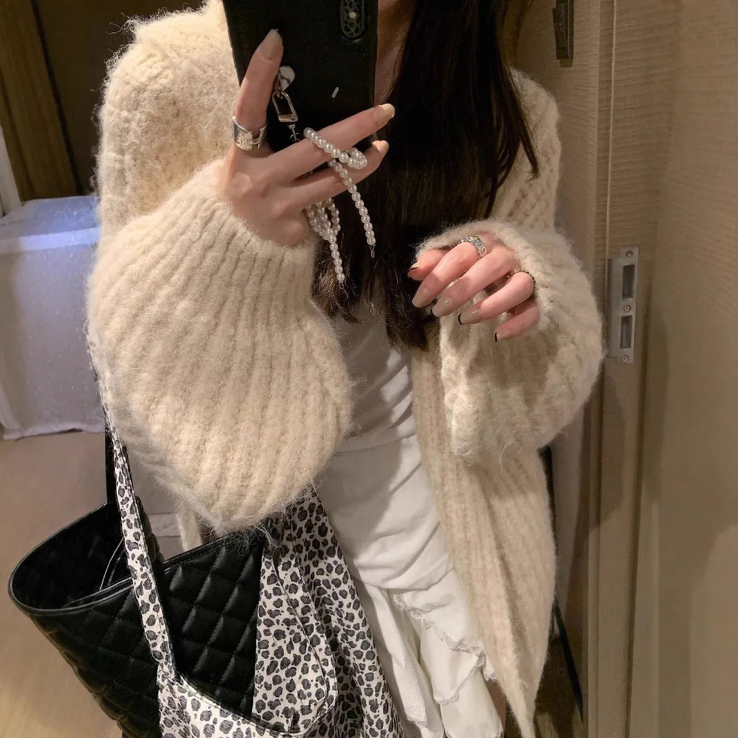 Women's loose-fit hooded cardigan in thick fabric, shown in dark grey, brown, and milky white colours.