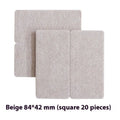 Assorted beige plastic furniture leg protectors in round and square shapes on hardwood floor