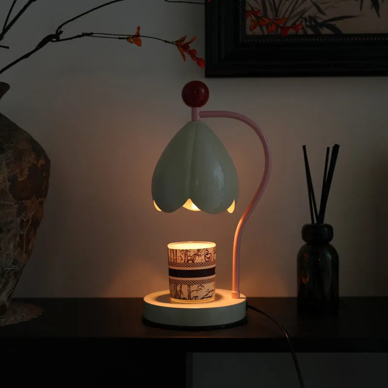 Linglan ancient style cream white melting wax lamp with metal holder on a desk.