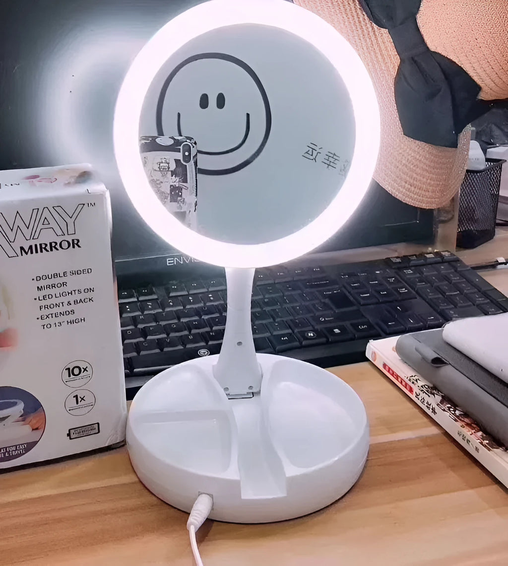 White foldable LED vanity mirror with a ring light, shown open on a table.