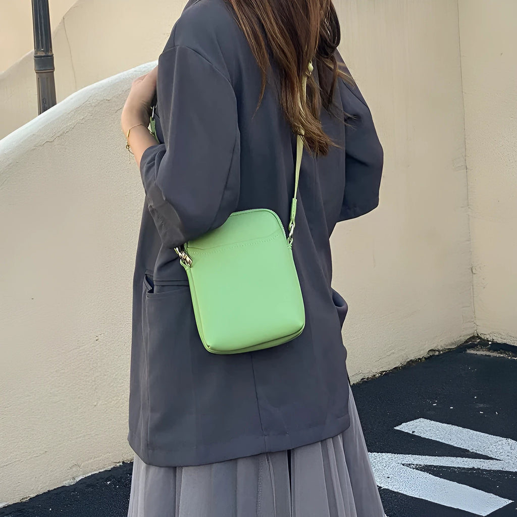 Simple solid colour PU leather crossbody phone bag for women shown in beige.