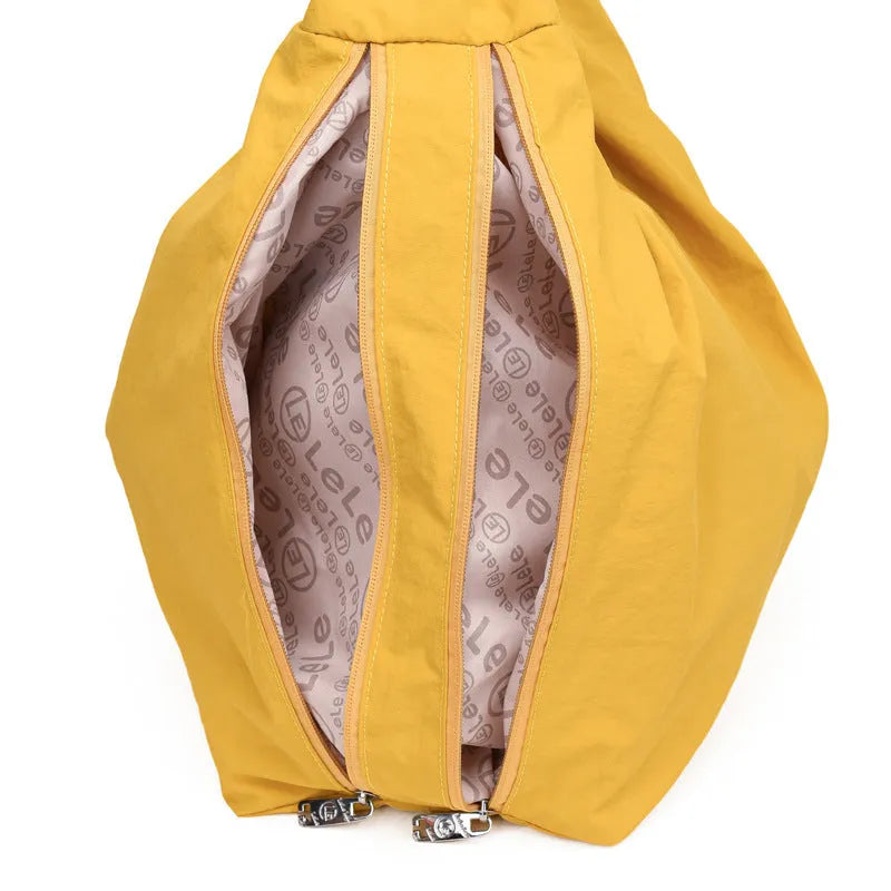 Nylon underarm bag in heart shape design showing large capacity, available in black, blue, khaki, and yellow colours