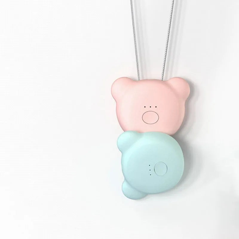 Mini USB portable air purifier necklace in pink, showing compact design with single button.