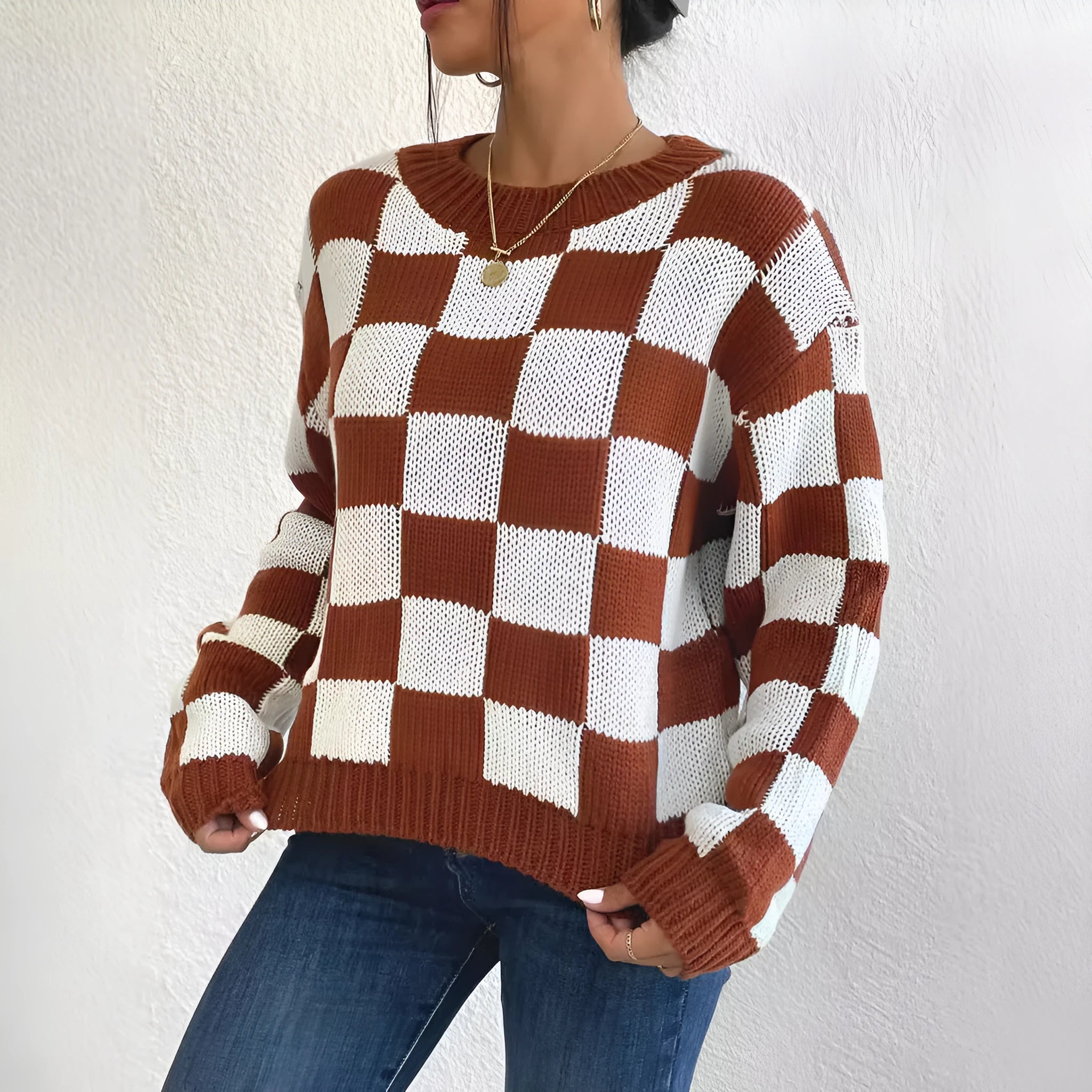 Dark brown plaid pattern acrylic pullover sweater with round neck and long sleeves on hanger