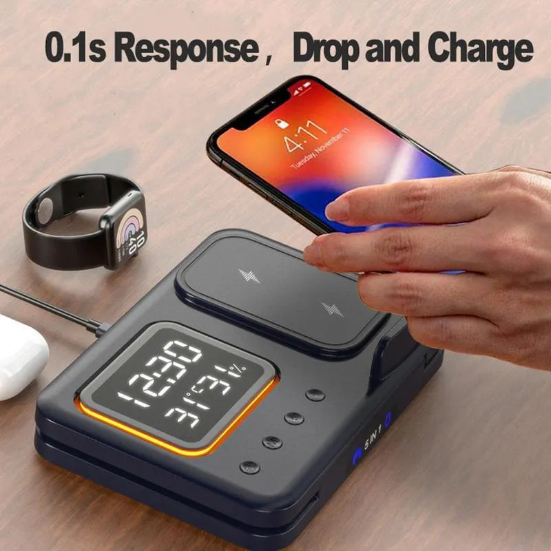 Black 15W wireless charging dock with phone, Apple Watch, and headphones on charging pads, showing LED digital clock display.
