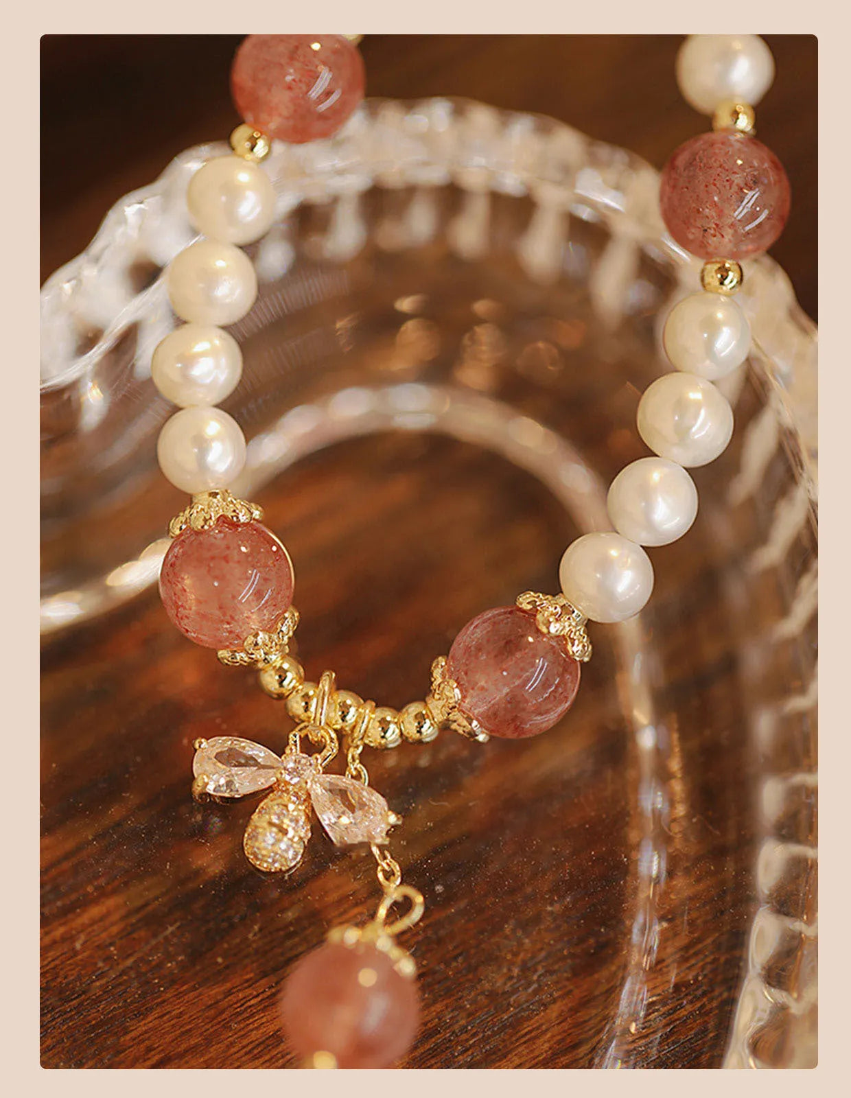 Women's strawberry quartz crystal bracelet with bow clasp closure on wrist