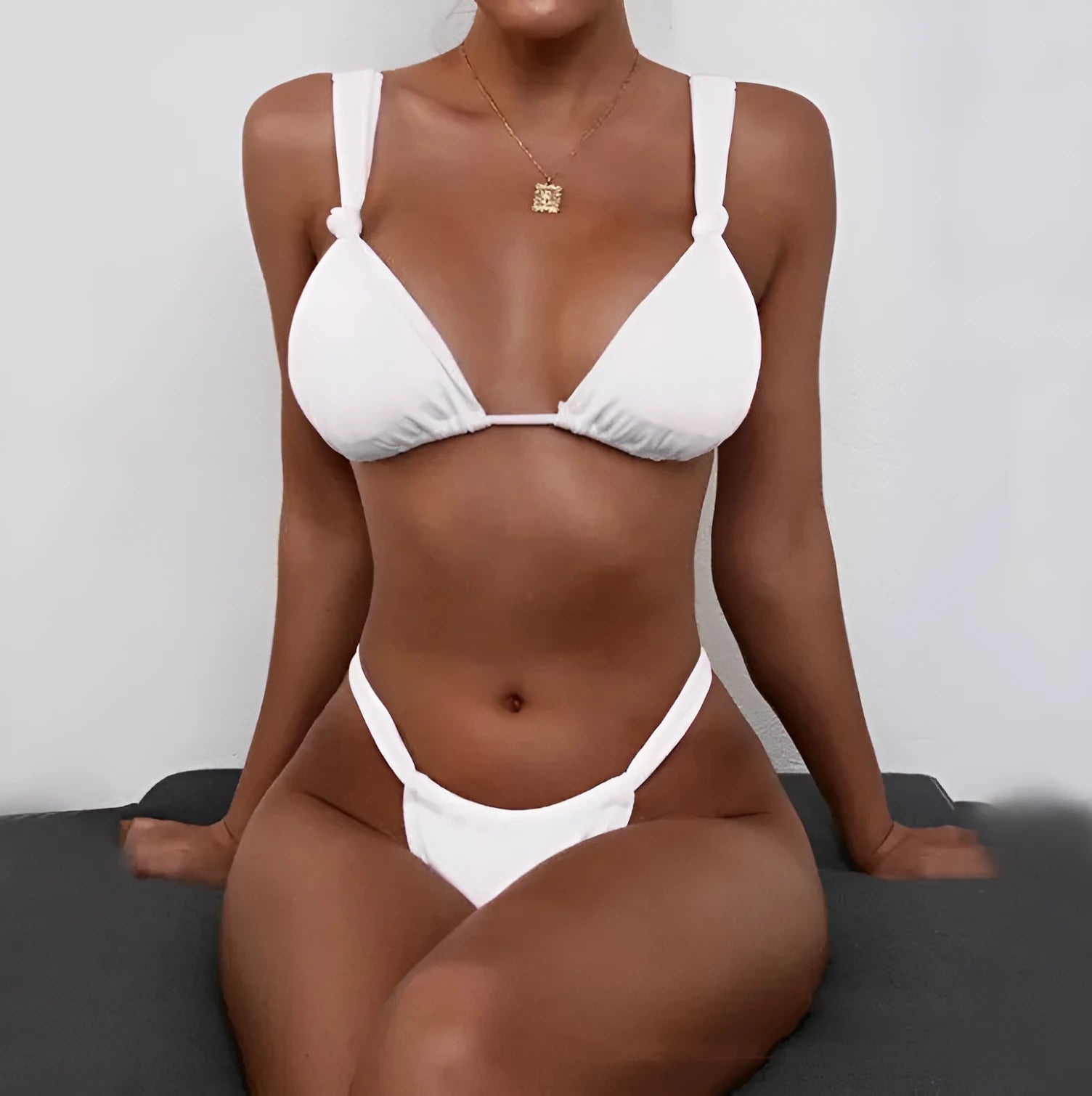 Women's pink pleated strap bikini with knot front and briefs bottom on mannequin