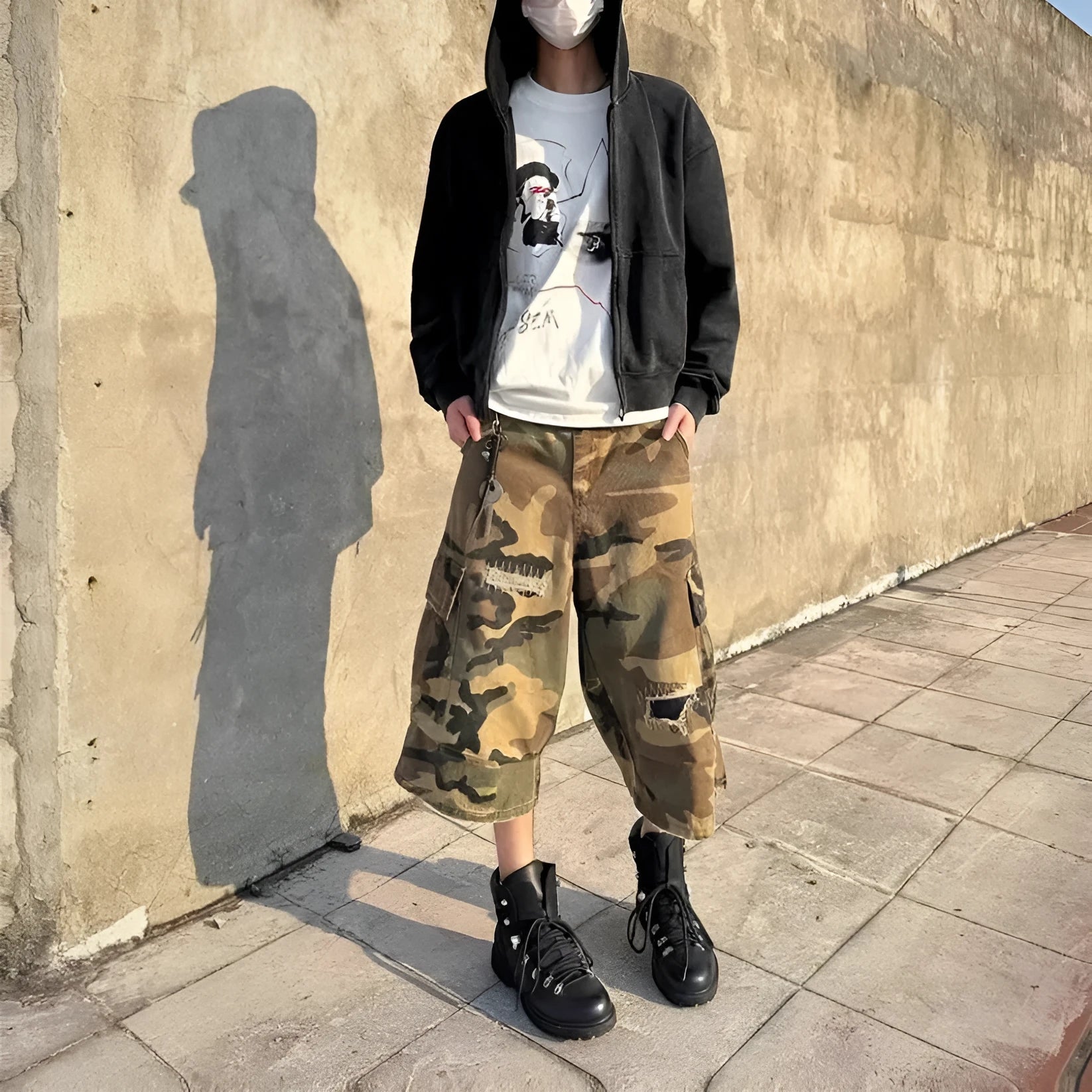 Men's retro patch ripped camouflage cropped jeans showing loose straight leg fit and distressed detailing