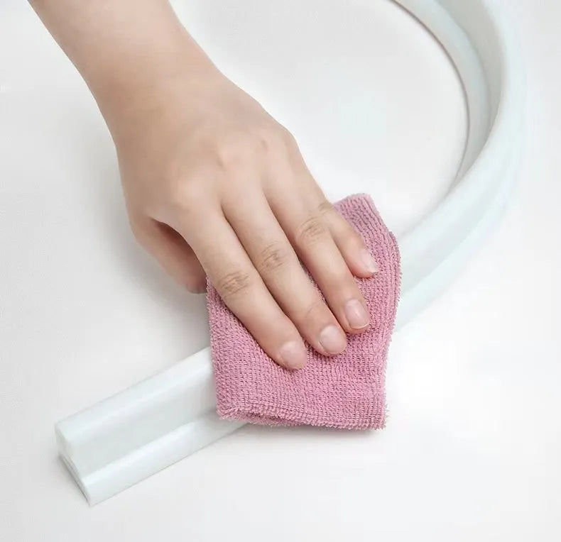 Flexible silicone bathroom waterproof strip in black colour showing water barrier installation