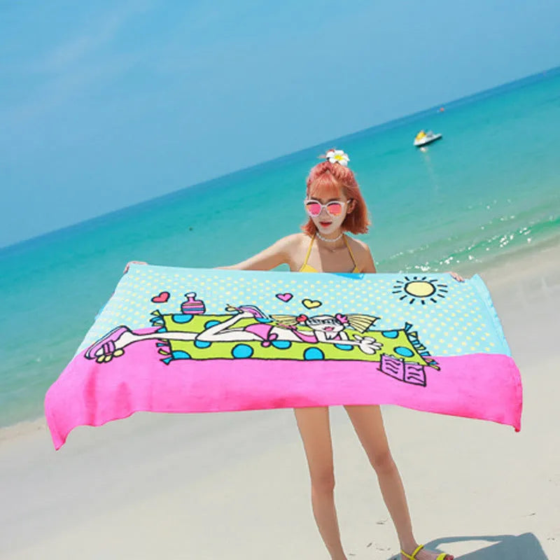 Flower-coloured swimming absorbent microfiber towel 150x70cm on a beach background