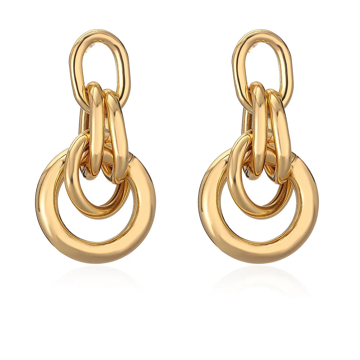 Gold geometric copper earrings with irregular asymmetric design on display