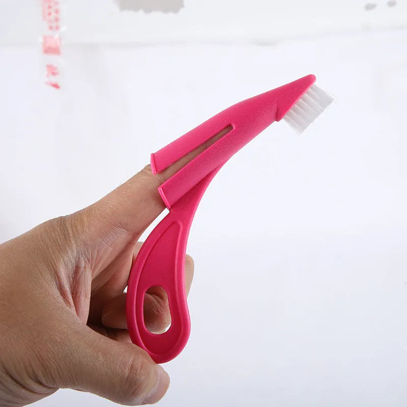 Red and white finger-sleeve pet toothbrush with soft silicone bristles for dog and cat dental cleaning.