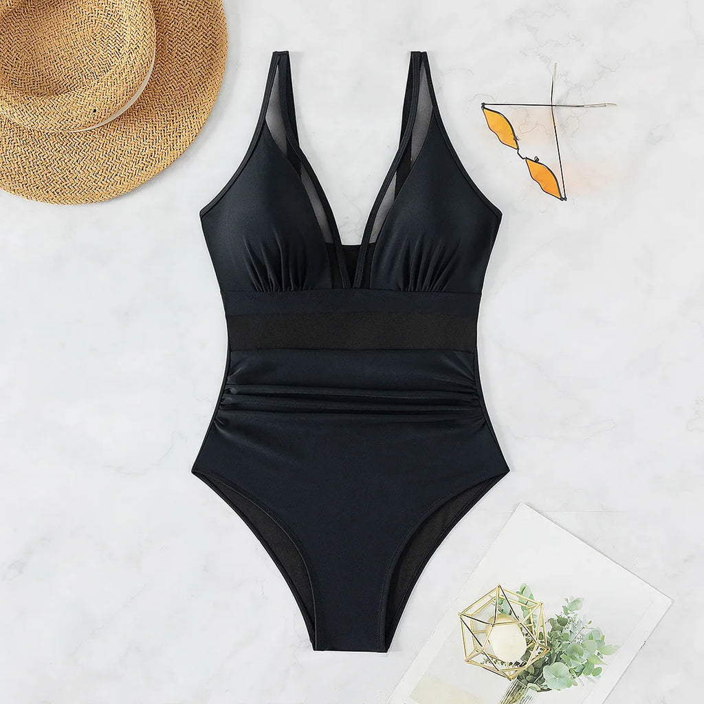 Black women's halter bikini one-piece swimsuit with mesh detailing and briefs style.