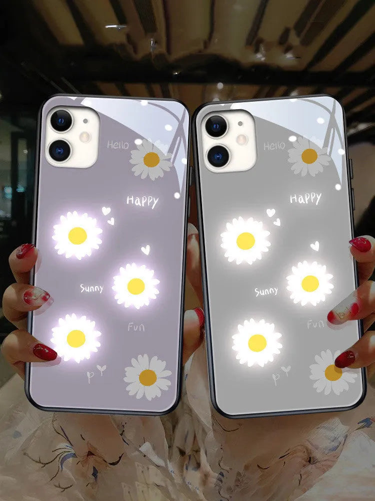 White iPhone case with painted purple daisies and lettering, illuminated with voice-activated colour-changing lights.