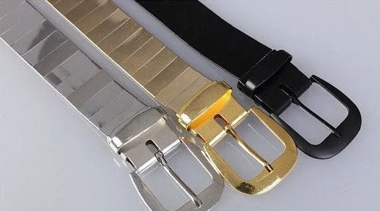Three shiny belts in gold, silver, and black metallic finish arranged together