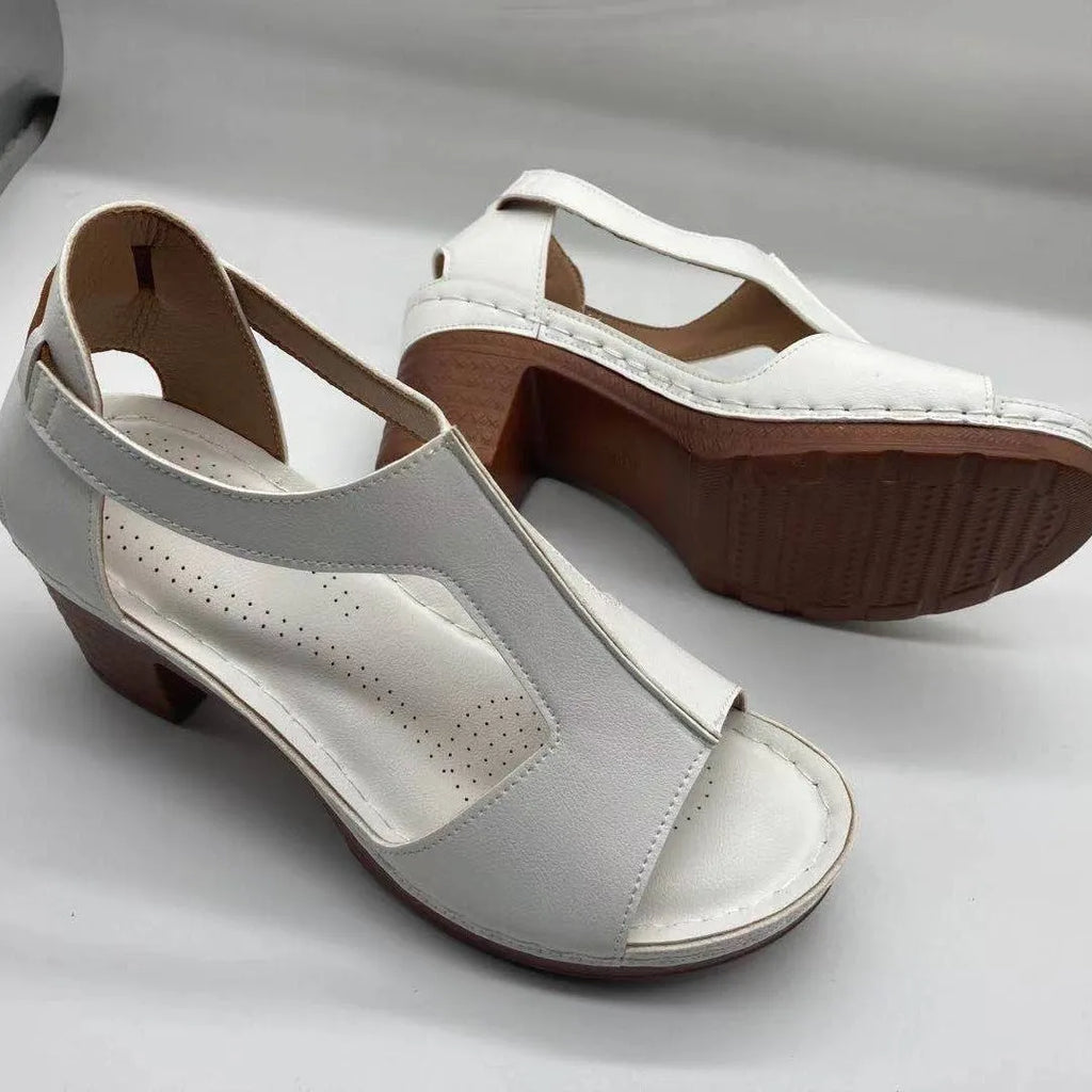 Women's plus size beige peep toe wedge sandals with a buckle strap and low heel.