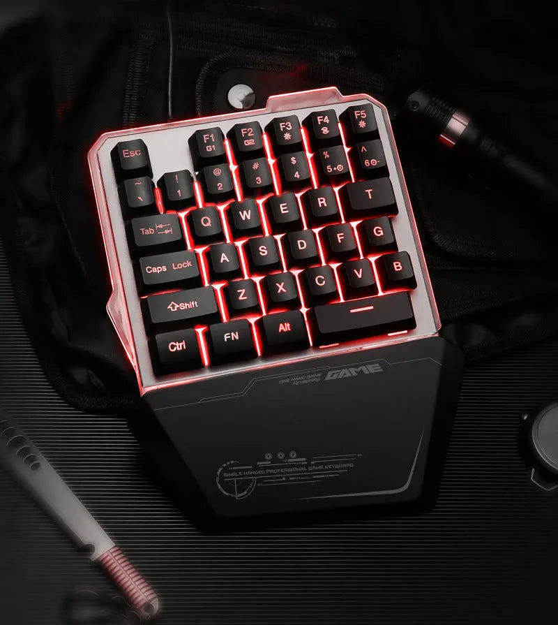 Black G40 Flow Colour one-handed mechanical keyboard with RGB backlit keys on a desk.
