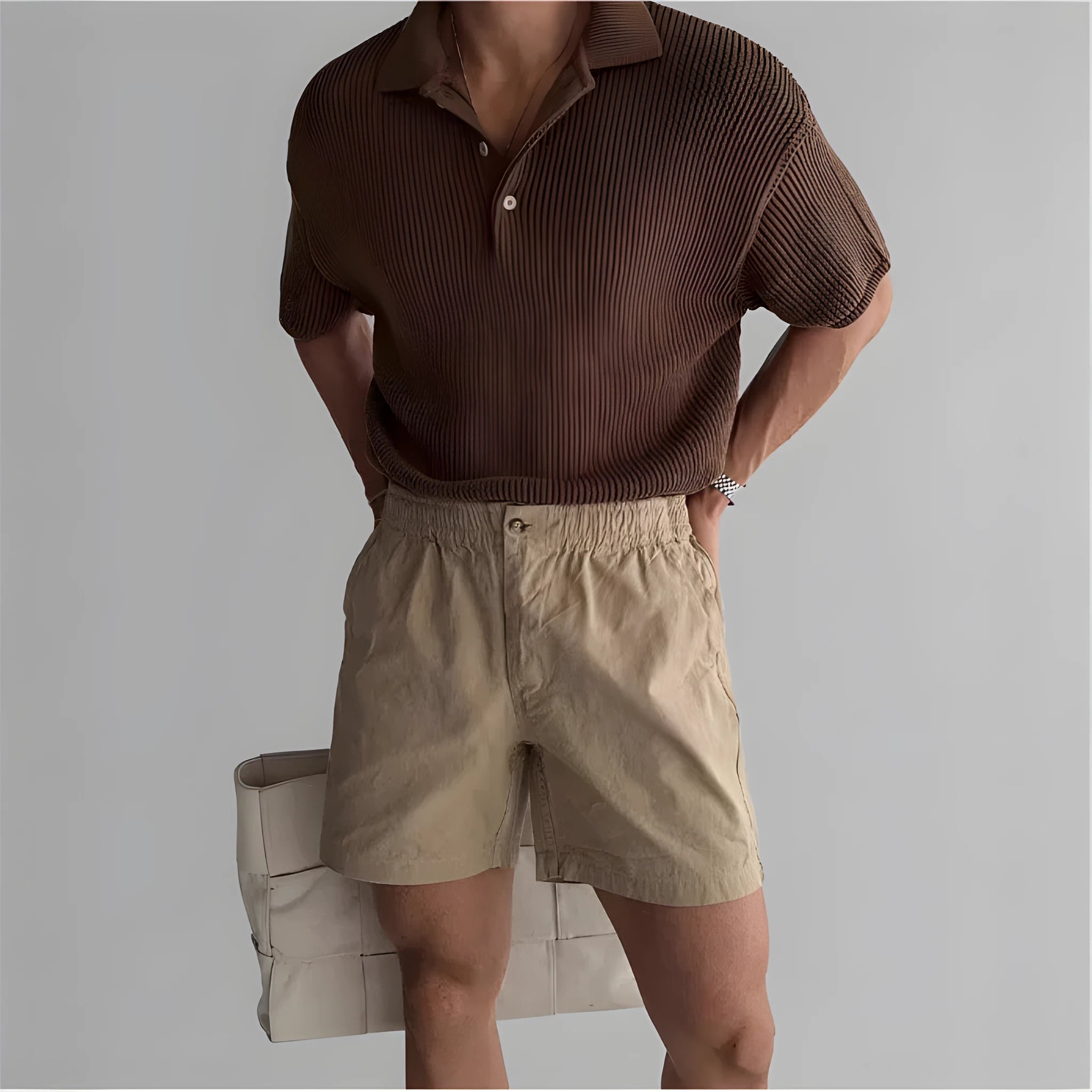 Men's loose-fit cotton sports shorts in khaki colour on a hanger.