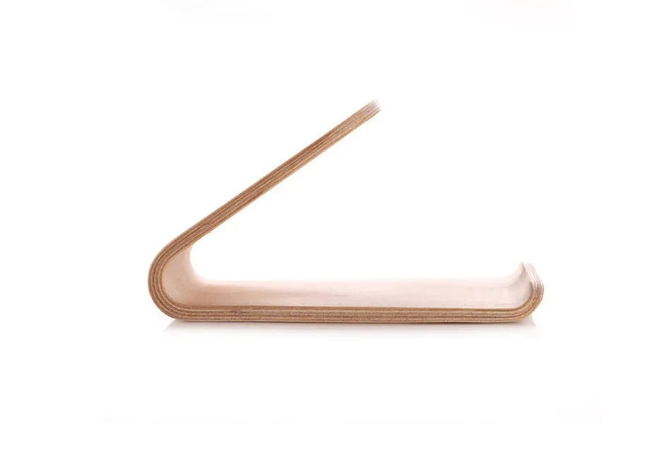 Solid walnut wooden iPhone stand holding a phone at an angle on a desk
