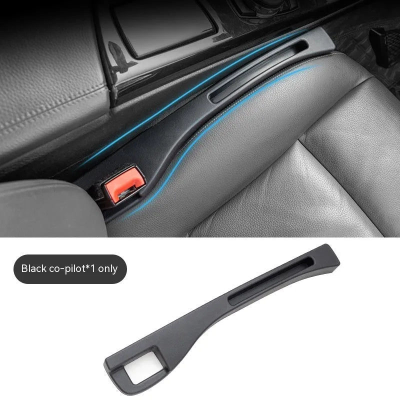 Black plastic car seats gap storage box with handle between driver seat and centre console