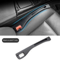 Black plastic car seats gap storage box with handle between driver seat and centre console