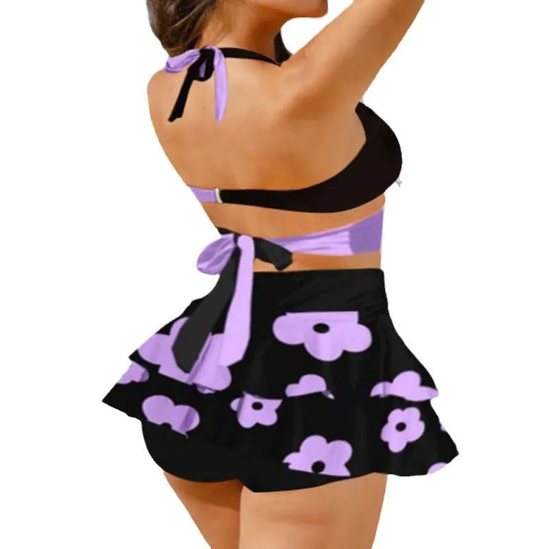 Women's purple two-piece swimsuit with separate skirt and lace-up details on high-waisted briefs