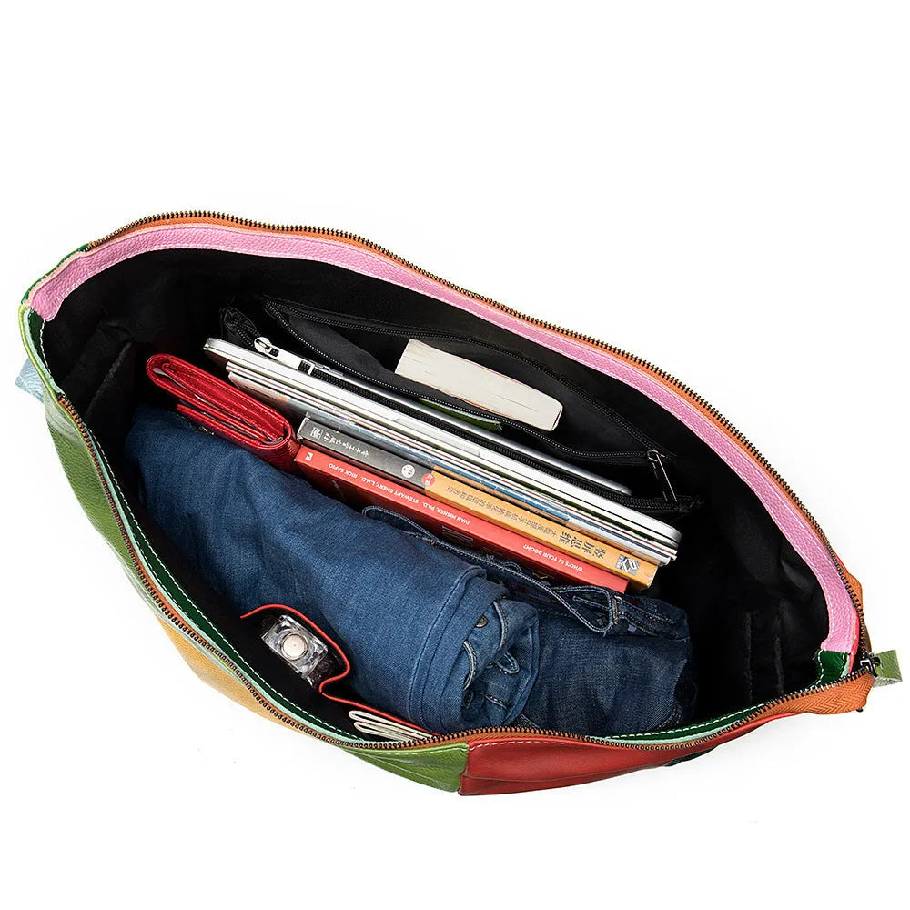 Brown cowhide leather crossbody travel bag open to show space for a laptop and A4 magazines.