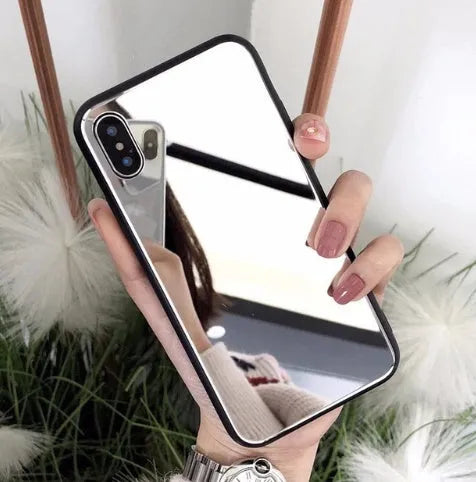 Black iPhone case with a mirrored back panel, shown next to an iPhone.