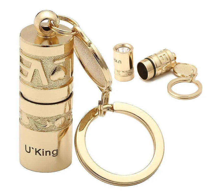 Gold zinc alloy waterproof LED keychain flashlight on a keyring.
