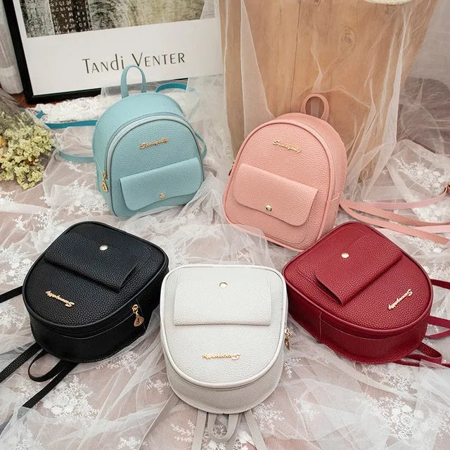 Small black PU women's backpack purse shown as a shoulder bag, with zipper closure and compact size.