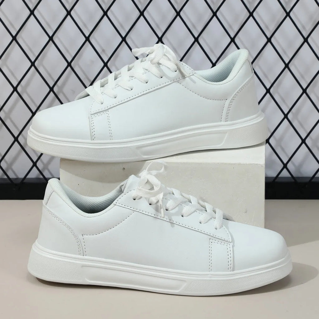 Beige brown casual platform sneakers with a cross strap and round toe on a rubber sole.