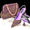 Women's pointed toe high heel shoe and small matching handbag set on a plain background.