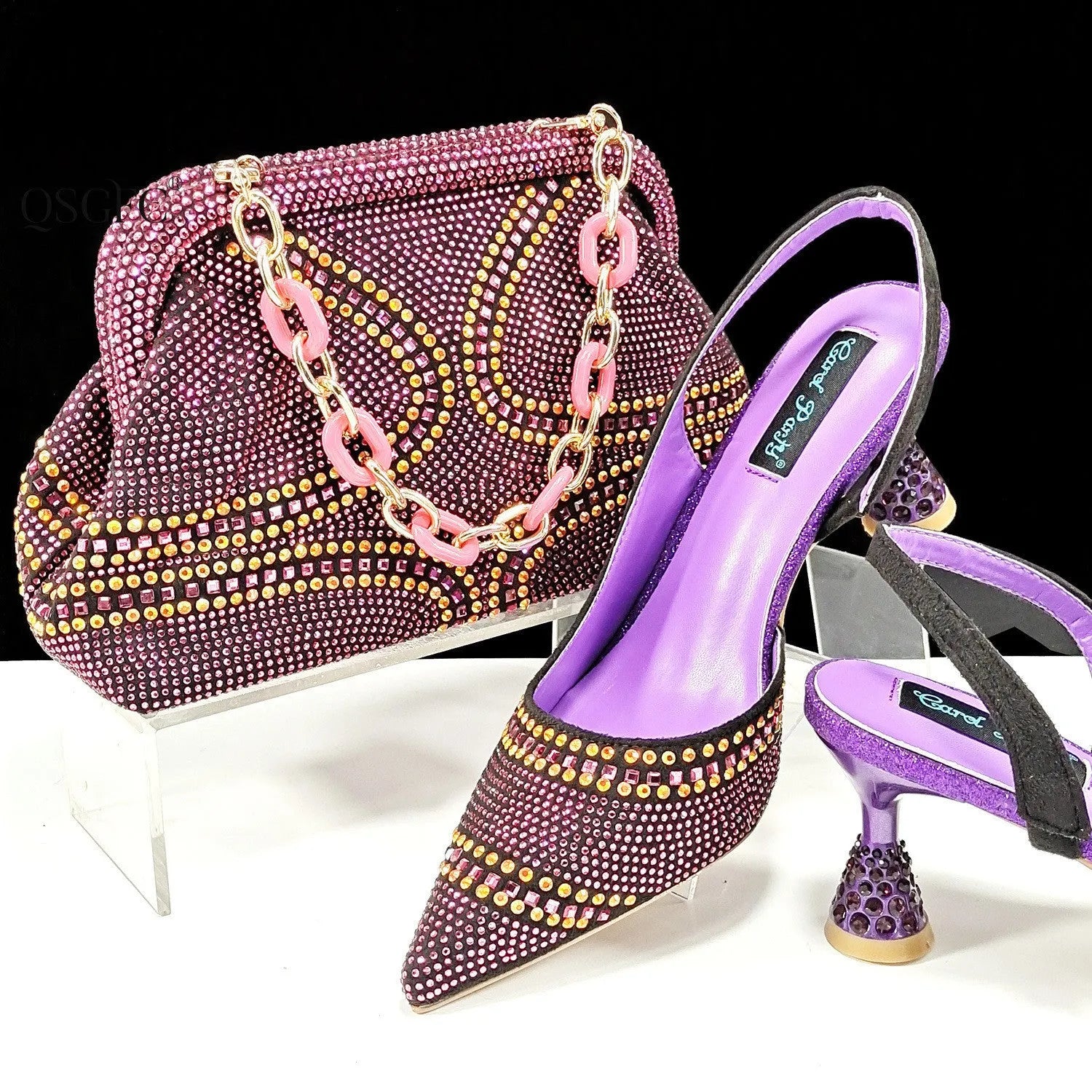 Women's pointed toe high heel shoe and small matching handbag set on a plain background.