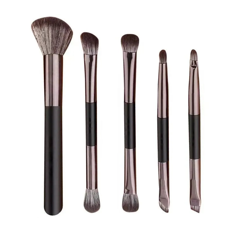 Silver and gold portable makeup brush sets with mirror case open showing eyeshadow brushes.