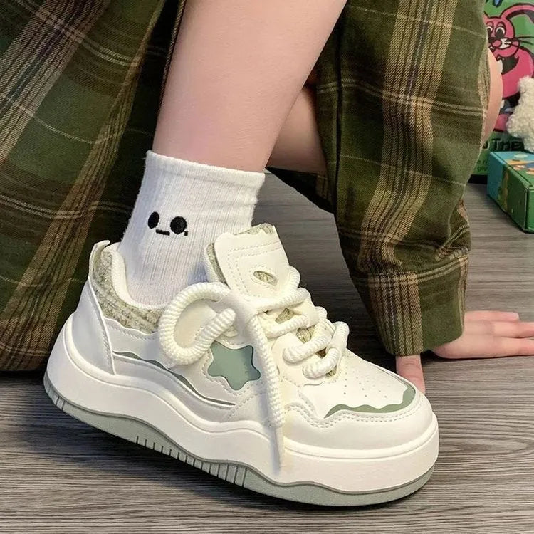 Women's green platform sneakers with patent leather finish, round toe, and lace-up front