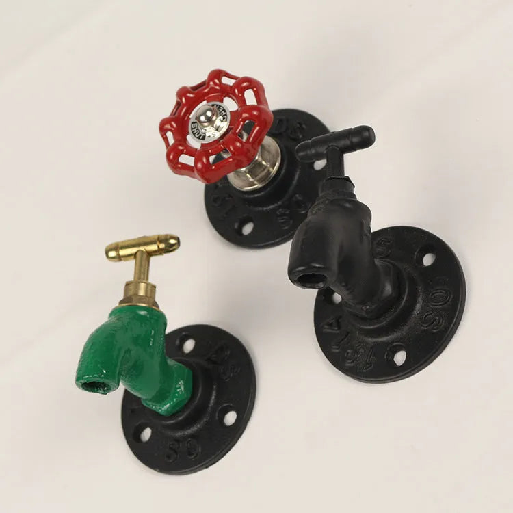 Modern water pipe style metal towel rack hook mounted on a wall in black finish.