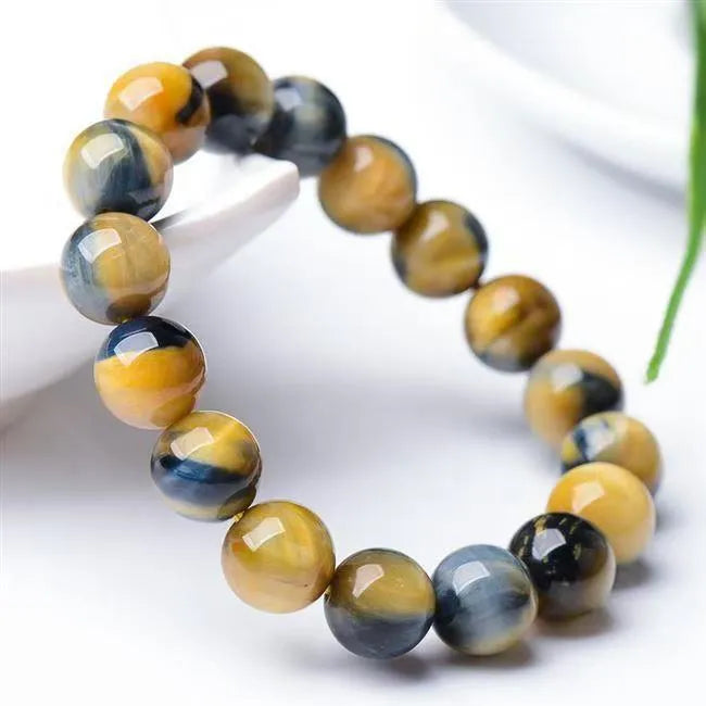 Fantasy Tiger Eye agate bracelet with round beads on a wrist, showing 10mm bead size.