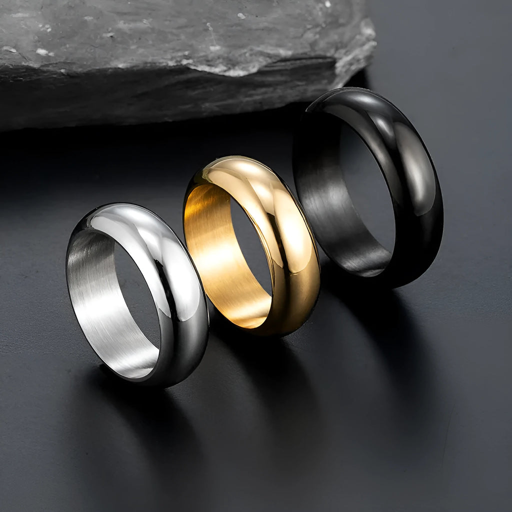 Glossy electroplated titanium steel ring in gold colour on a plain background.