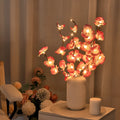 65cm tall pink LED phalaenopsis branch decorative light with fabric and plastic shell on bedside table