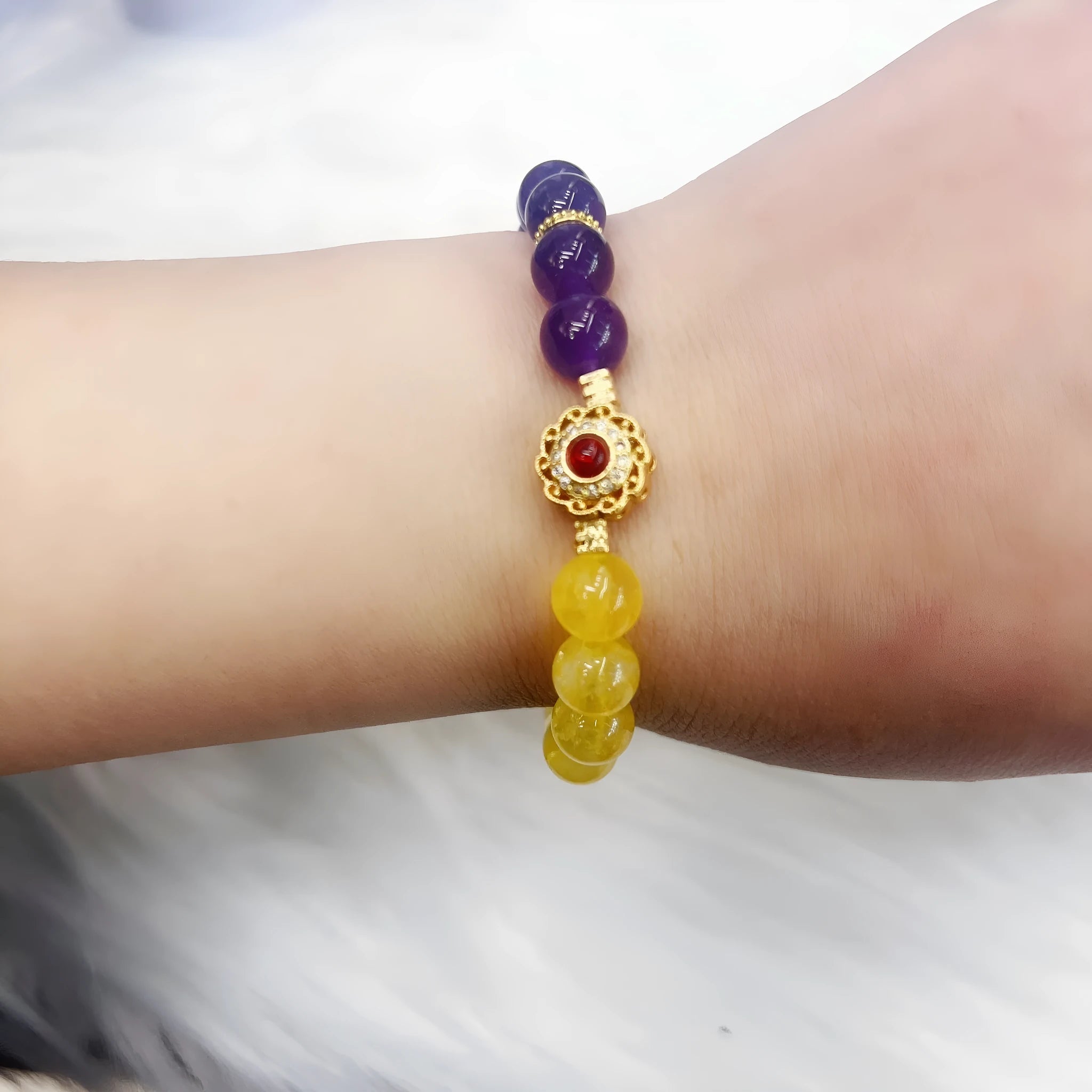 Handmade women's bracelet with yellow and purple crystal amethyst stones on adjustable clasp