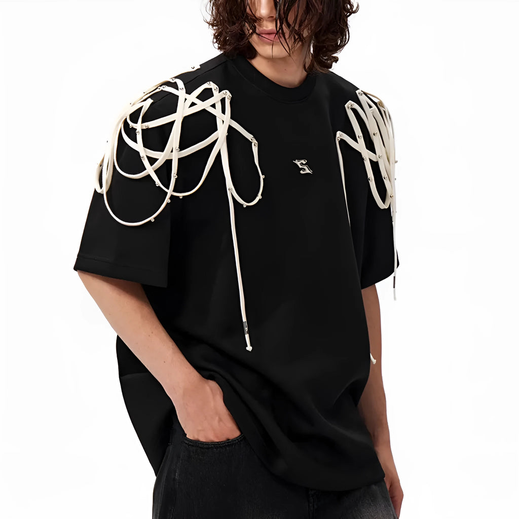Black loose-fit short-sleeved t-shirt showing padded shoulder detail with rivet ribbon.