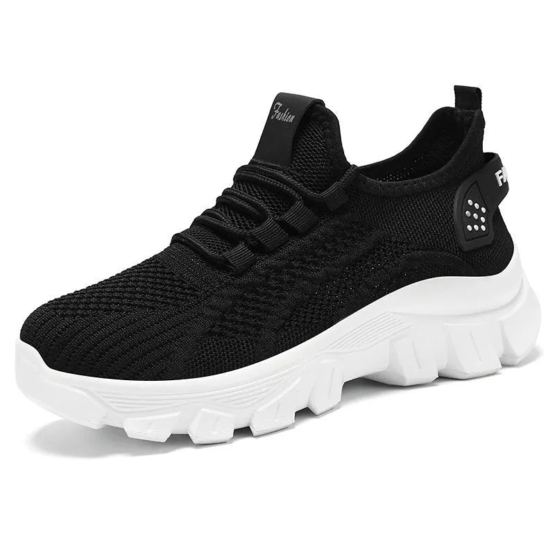 Women's white Flyknit sneakers with thick PVC sole and lace-up front.