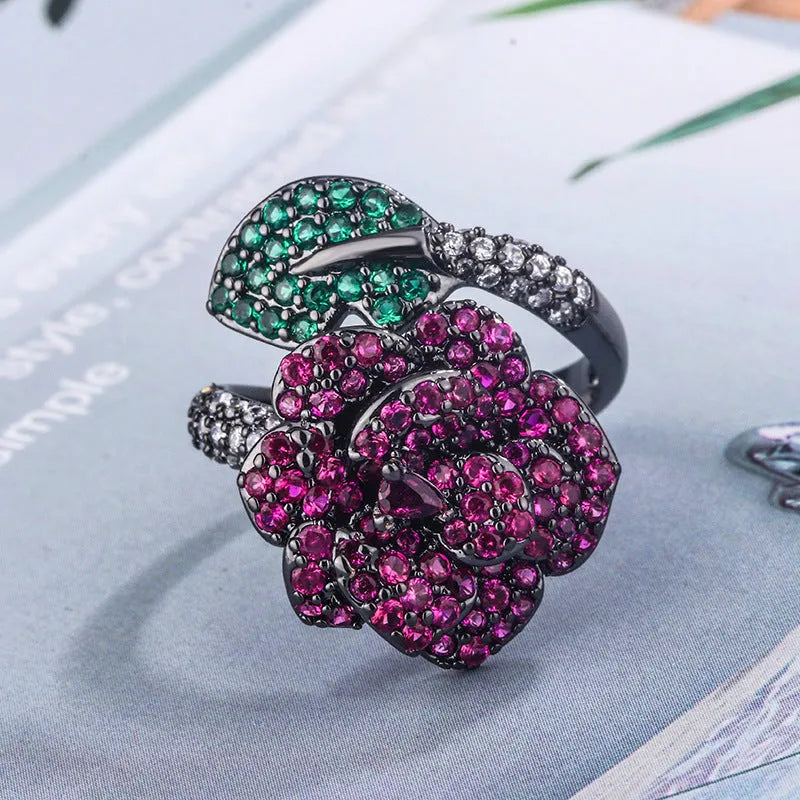 Gold-plated women's ring with a geometric black gold flower design and simulated red corundum detail.