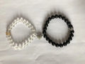 2pcs handmade glow-in-the-dark crown beaded bracelets in white and black with glass beads and luminous heart charm