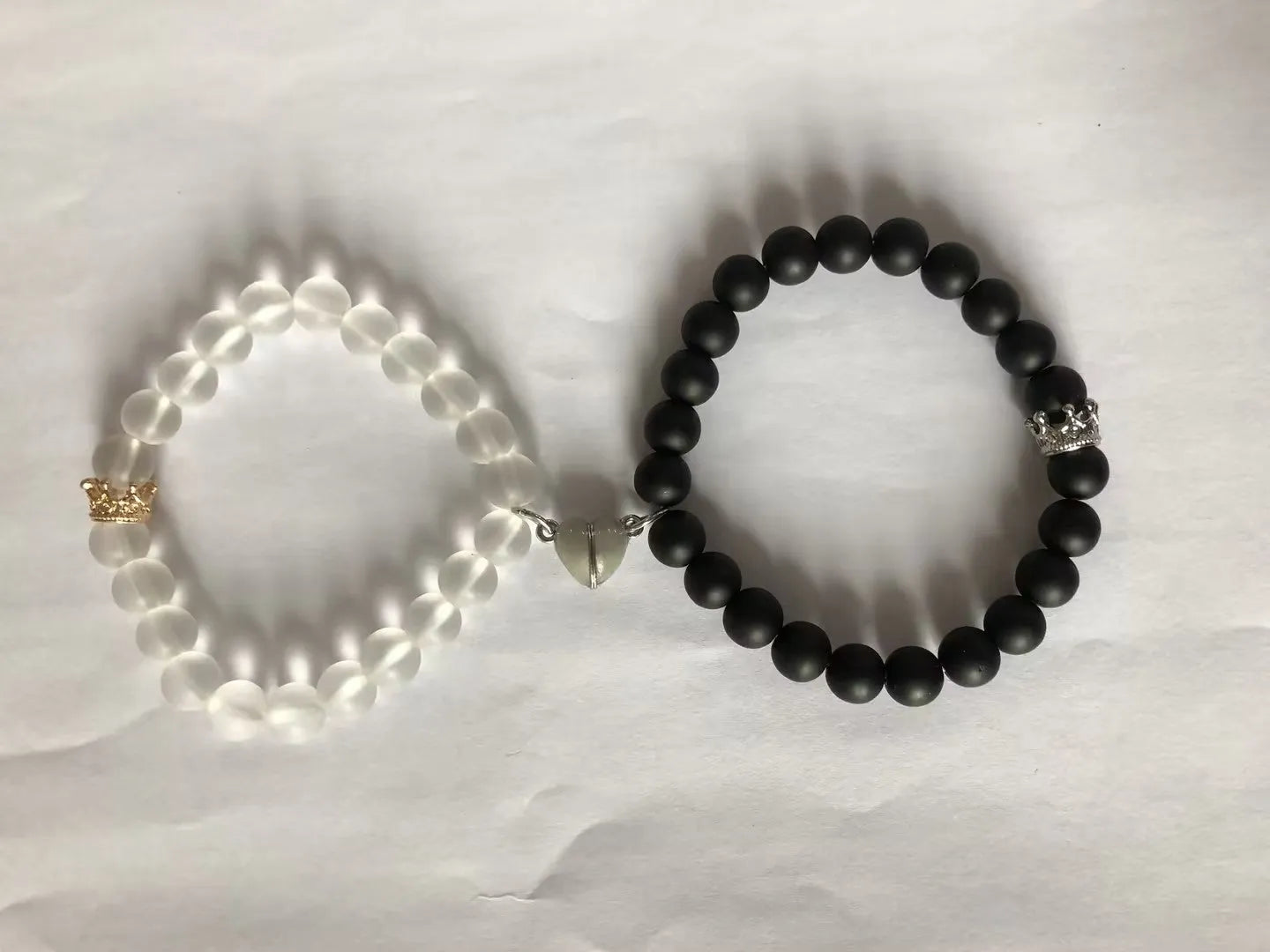 2pcs handmade glow-in-the-dark crown beaded bracelets in white and black with glass beads and luminous heart charm