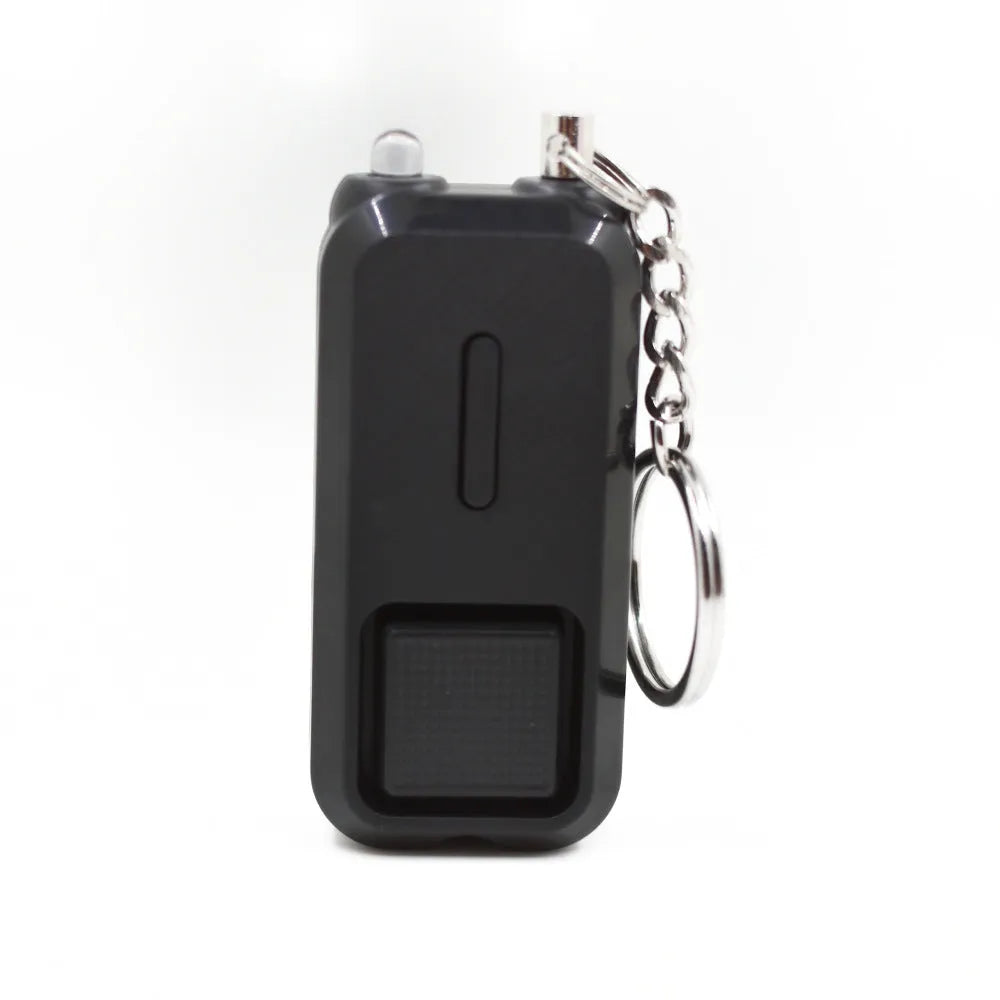 ZQ-202 personal safety alarm in pink, showing compact size next to a ruler for scale.